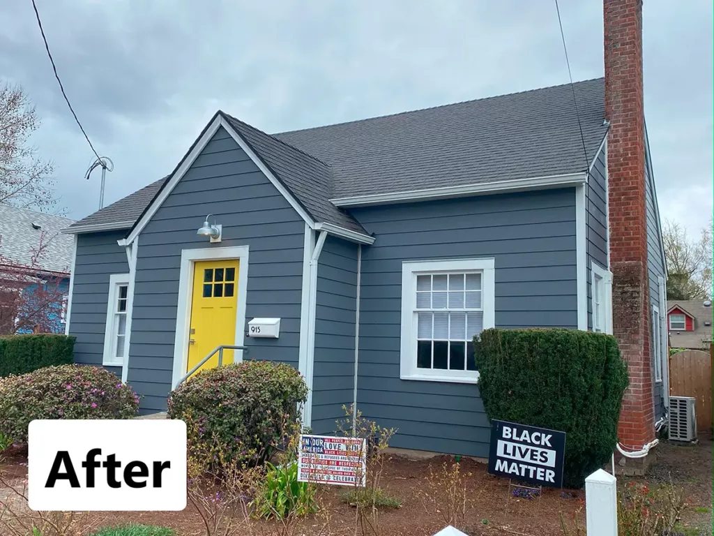 single family home after siding installation with grey blue exterior paint and yellow door painted